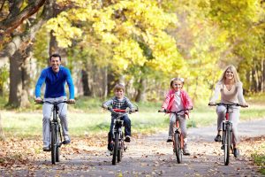 Family on bikes in the park